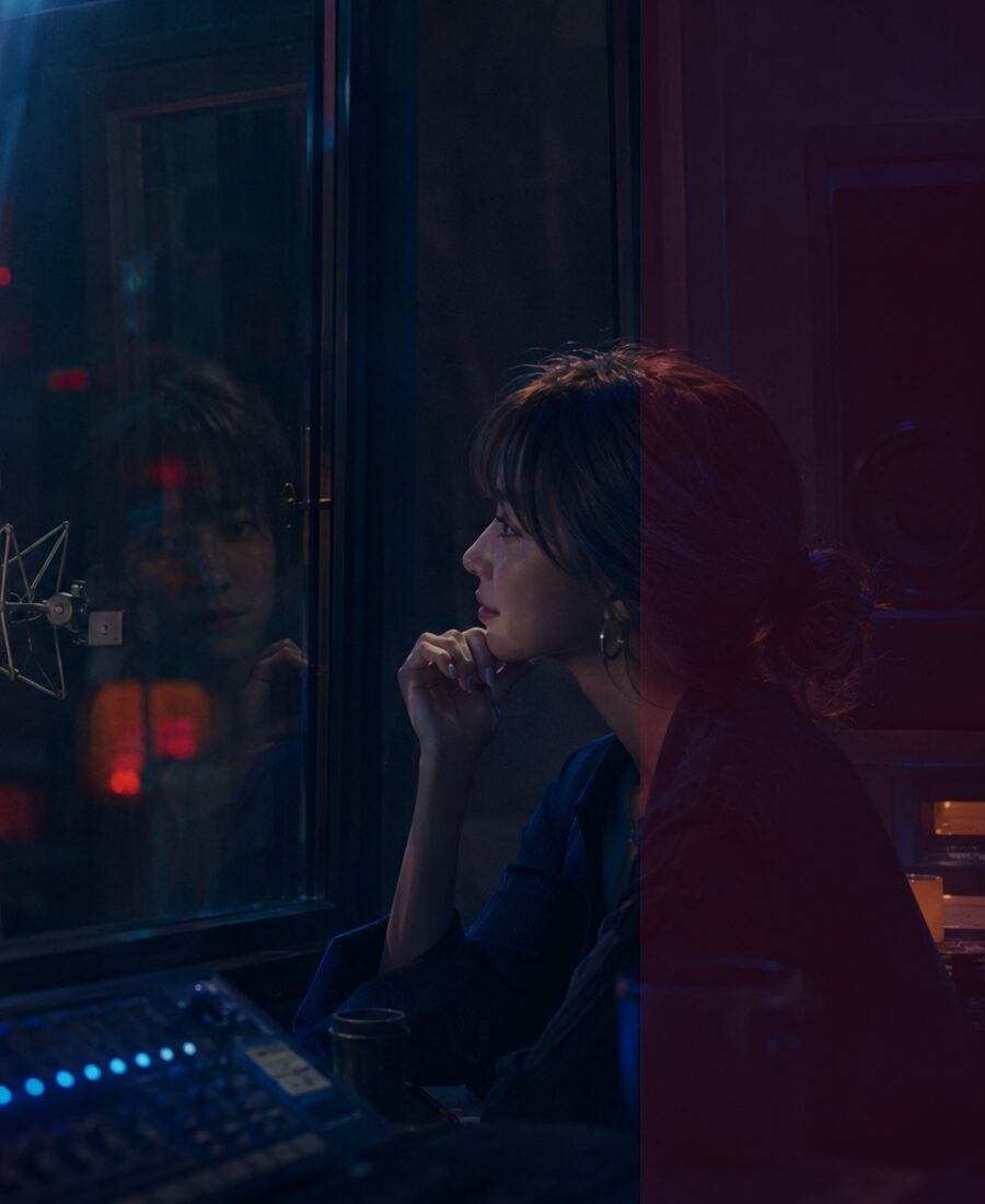Recording studio glass between Matt and Jo.